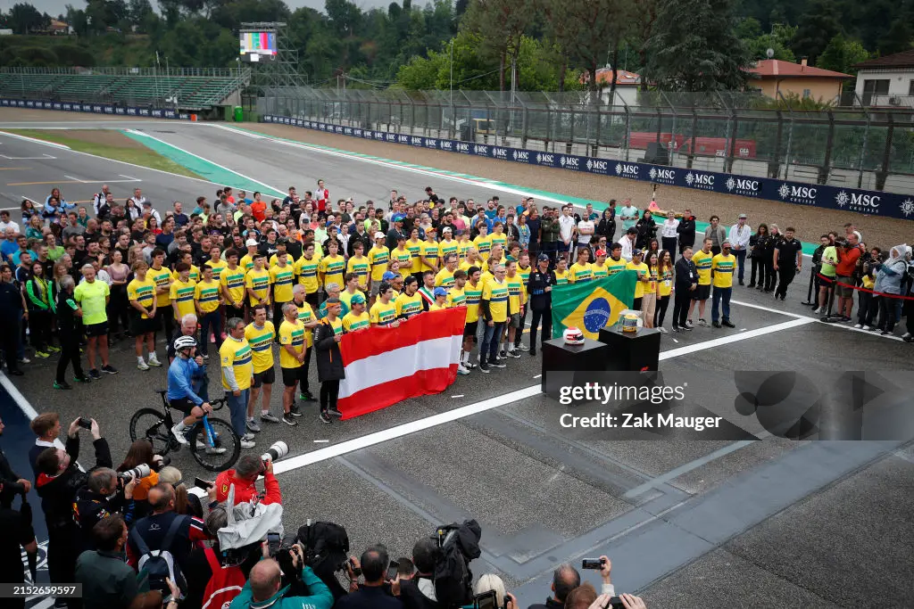 imola-italy-drivers-of-the-formula-1-formula-2-and-formula-3-paddocks-stand-on-the-grid-in.webp