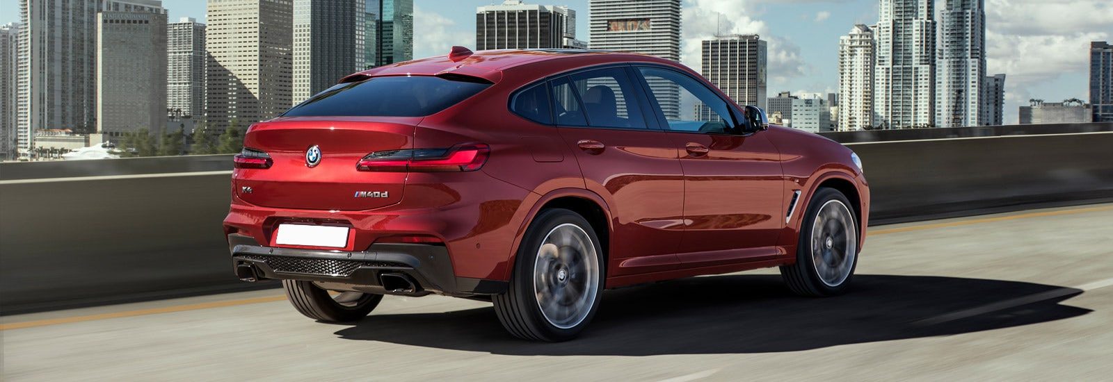 bmw-x4-red-rear-driving-m40d-1.jpg