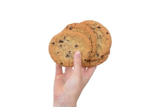 homemade-chocolate-chip-cookies-in-a-childs-hand-picture-id951136594