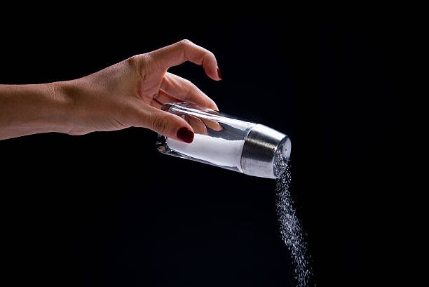 salt-shaker-pouring-granules-picture-id495329922