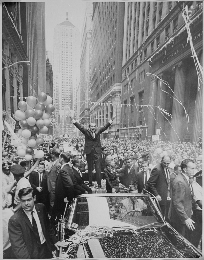 lossy-page1-800px-Richard_M._Nixon_in_a_campaign_motorcade_standing_on_the_back_of_car_give_the_%22V%22_sign._-_NARA_-_194666.tif.jpg